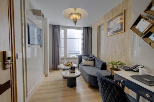 a living room with a blue couch and a table at Empire Platinum Suites in New Delhi