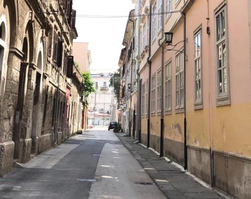 an empty street in an alley between buildings at Lovely apartment in the heart of Pula in Pula