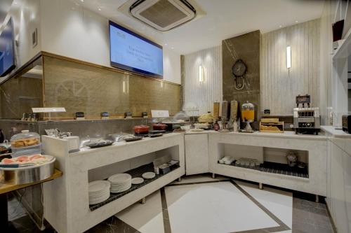 a kitchen with a counter with food on it at Empire Platinum Suites in New Delhi