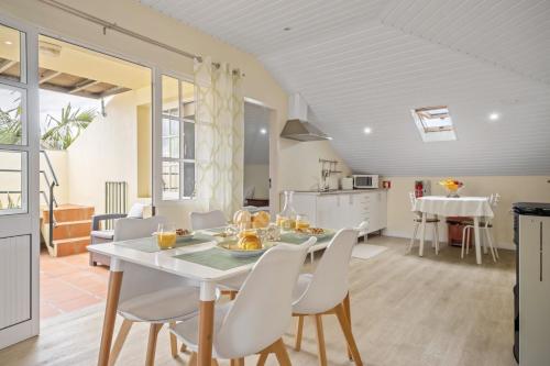 a kitchen and dining room with a table and chairs at Eyes in the Sky in Funchal