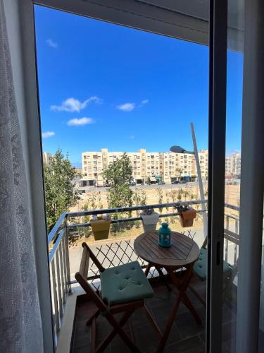 a balcony with a table and a view of a city at Shems Bouznika kettani in Bouznika