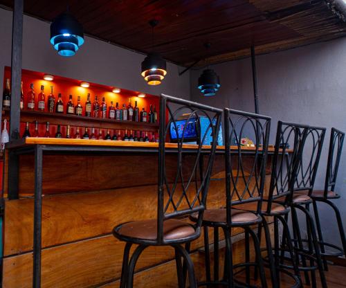 a bar with four chairs in front of a counter at The Lodge-Stack By Kabachi in Lagos