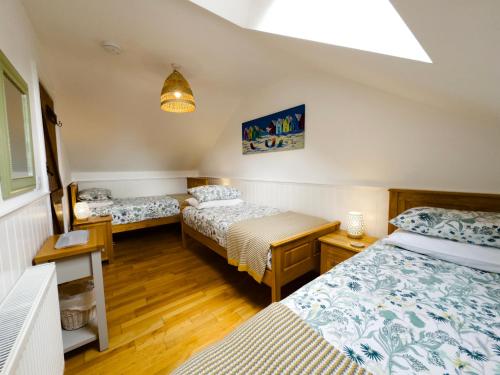 a room with two beds and a light at Vale View Cottages - The Stables in Prestatyn