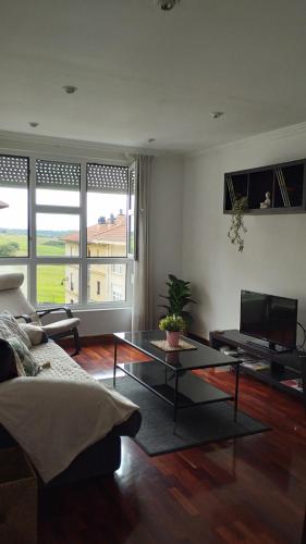 a living room with a couch and a coffee table at R2R - Apartmento Aire del Mar - C11A02 in Liencres
