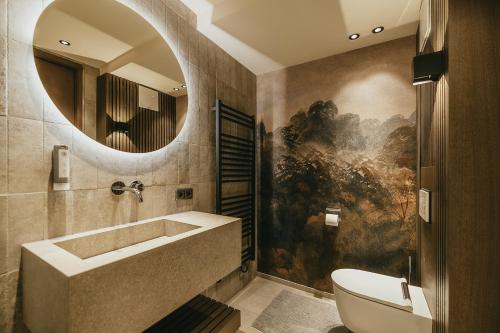 a bathroom with a tub and a sink and a mirror at The Black Eagle Luxury Appartements in Mayrhofen