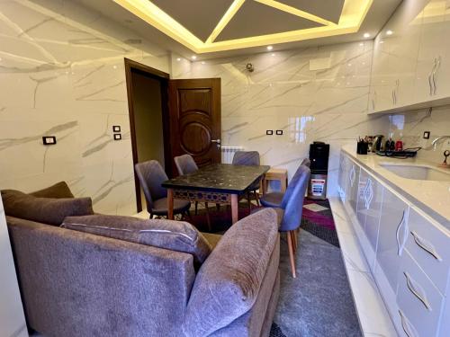 a living room with a couch and a table at Ksara Zahle - Luxurious two bedroom apartment in Zahlé