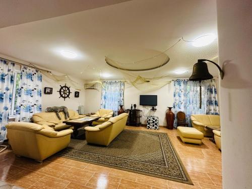 a living room with couches and a table at Claude Monet beach hotel in Ureki