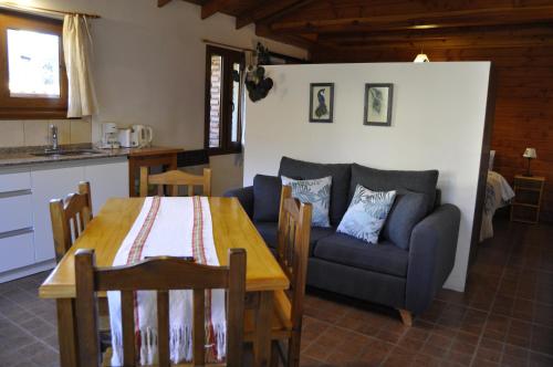 a living room with a table and a couch at La Aljaba in El Bolsón