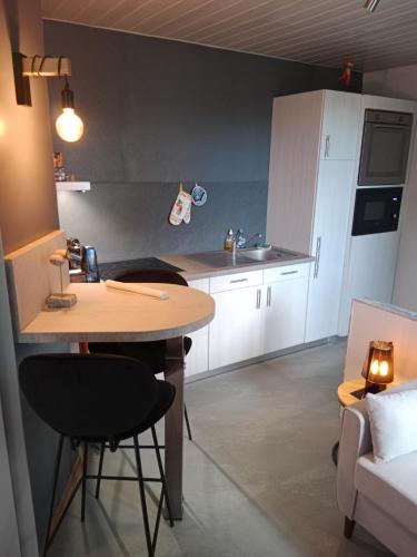 a small kitchen with a table and a couch at I have a dream in Colmar
