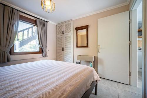 a bedroom with a large bed and a window at Kalkan lovely 1 bedroom holiday rental in Kas