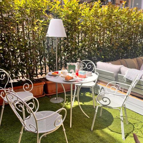 a patio with a table and chairs and a couch at Relais Villa Migliorini in Ercolano