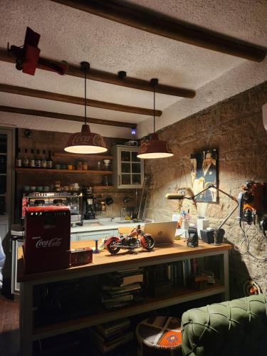a kitchen with a table with a laptop on it at Assos Sunset Hotel in Behramkale