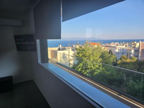 a window in a room with a view of a city at Pinecone in Kavala