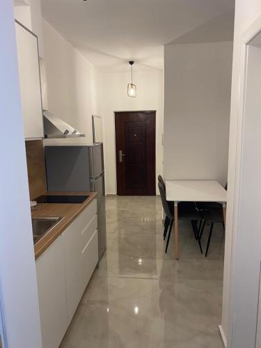 a kitchen and dining room with a table and a dining room at AJ Apartments in Orikum