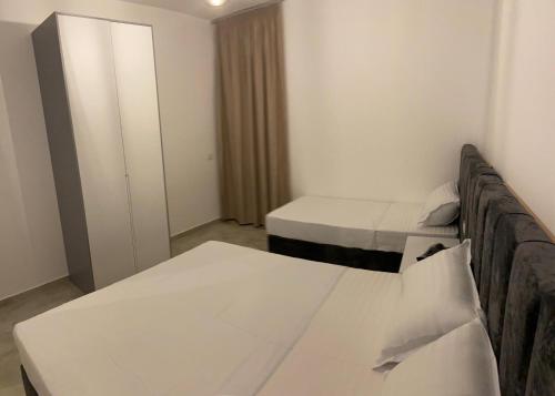a small room with two beds and a closet at AJ Apartments in Orikum