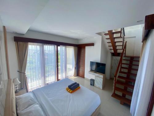 a bedroom with a bed with a suitcase on it at SONGOKU HOUSE APARTMEN in Pesanggaran