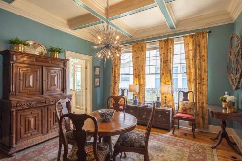 a dining room with a table and chairs and a window at Midtown Central Gardens Bungalow in Memphis