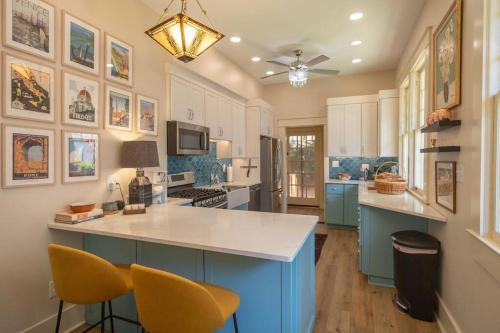 a kitchen with blue cabinets and a white counter top at Midtown Central Gardens Bungalow in Memphis