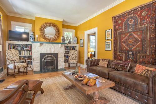 a living room with a couch and a fireplace at Midtown Central Gardens Bungalow in Memphis