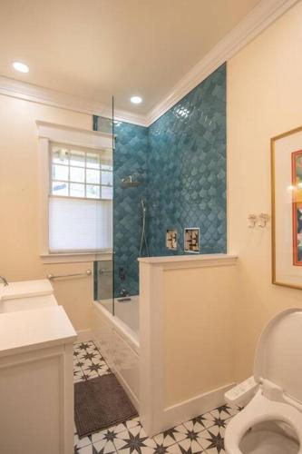 a bathroom with a shower and a toilet at Midtown Central Gardens Bungalow in Memphis