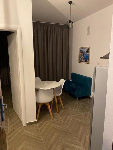 a living room with a table and a couch at AJ Apartments in Orikum