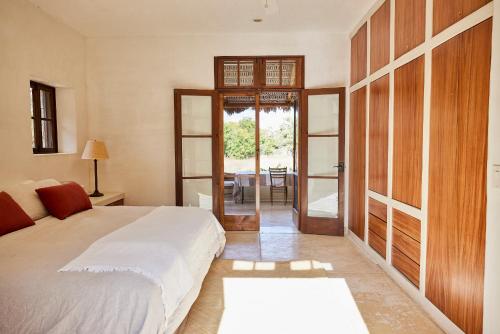 a bedroom with a bed and a sliding glass door at Casa Piedra - Close To The Beach! in Todos Santos