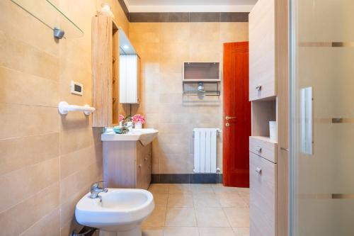 a bathroom with a white toilet and a sink at Villa Laura in Capoterra