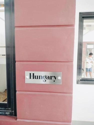 a pink dresser with the wordhungary written on it at MGM Guest House in San Felix