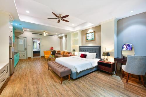 a bedroom with a bed and a living room at Sam Royal Apartment in Ho Chi Minh City