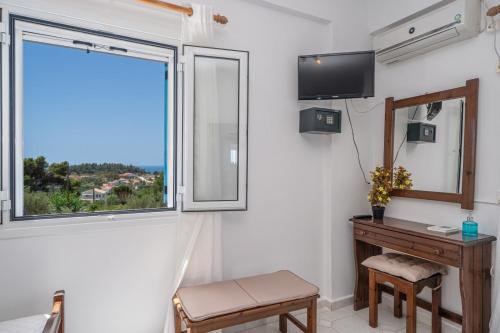 a room with a desk and a window at Fiore Di Mare Studios in Lassi