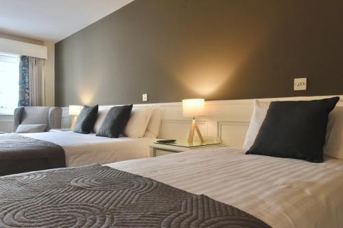 a hotel room with two beds and a couch at The Lough & Quay Accommodation in Warrenpoint
