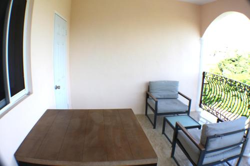 a dining room with a table and two chairs at Tamra’s Getaway in Montego Bay