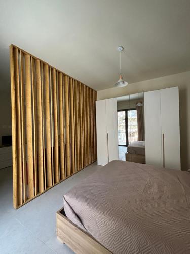 a bedroom with a bed and some sliding glass doors at La Corte degli Scolopi in Palma di Montechiaro