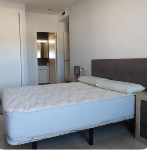 a large white bed in a room with at Apartamento Saul de Tarso in Beniarbeig