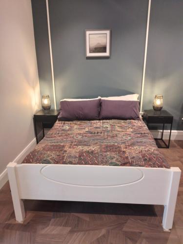a bed in a bedroom with two nightstands and two lamps at Teachín in Killarney