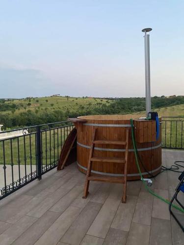 a wooden tub sitting on top of a deck at AS-Relax in Baile Felix