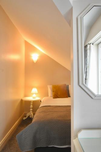 a small bedroom with a bed and a window at The Lough & Quay Accommodation in Warrenpoint