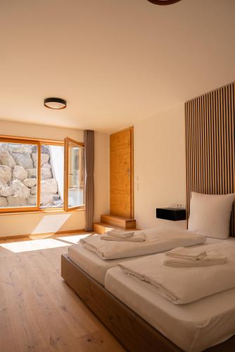 a hotel room with two beds and a window at Garten Chalet in Bayrischzell