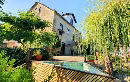 a swimming pool in the yard of a house at Casa do Fundo - Sustainable & Ecotourism in Seia