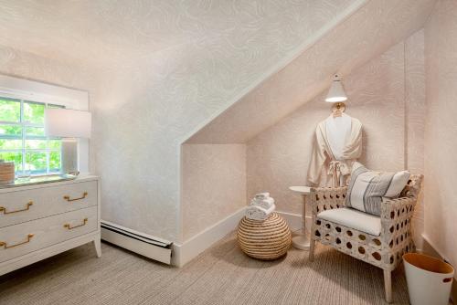 a dressing room with a chair and a dresser at The Martin in Nantucket