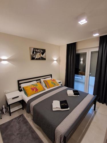 a bedroom with a bed with two books on it at Apartmani Datea in Grebaštica