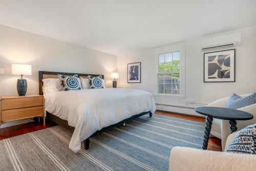 a bedroom with a large bed and a couch at The Martin in Nantucket