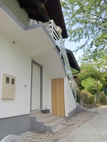 a staircase leading up to a house with a door at Apartman Deni in Tuzla