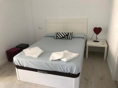 a bedroom with a bed with two towels on it at Carihuela Beach in Torremolinos