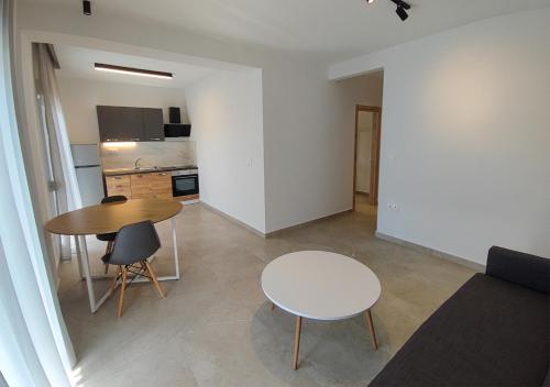 a living room with a table and a kitchen at K78 Studios A2 in Nea Michaniona