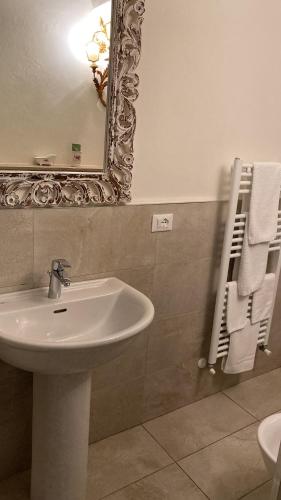 a bathroom with a sink and a mirror at Luxury apartment Suite La Fontana in Lucca
