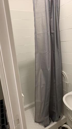 a shower curtain in a bathroom with a sink at Studio au centre Aubusson in Aubusson