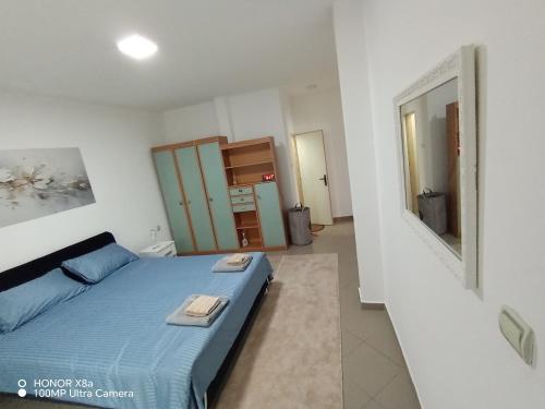 a bedroom with a blue bed with towels on it at Predah Vranje in Vranje