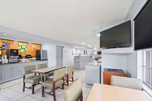 a kitchen and dining room with a table and chairs at La Quinta Inn by Wyndham Corpus Christi North in Corpus Christi