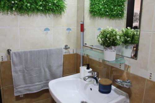 a bathroom with a sink and a mirror and a towel at Newly furnished 1 Bedroom, high floor, amazing view, close to metro in Dubai